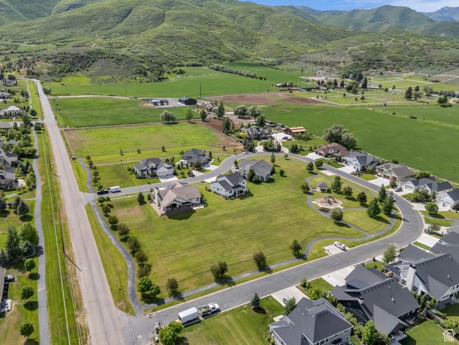 Aerial overview of property's location featuring a mountainous background, nearby suburban area, and rural landscape | Image 63