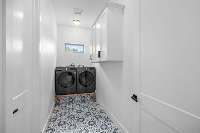 Laundry area with cabinet space | Image 25