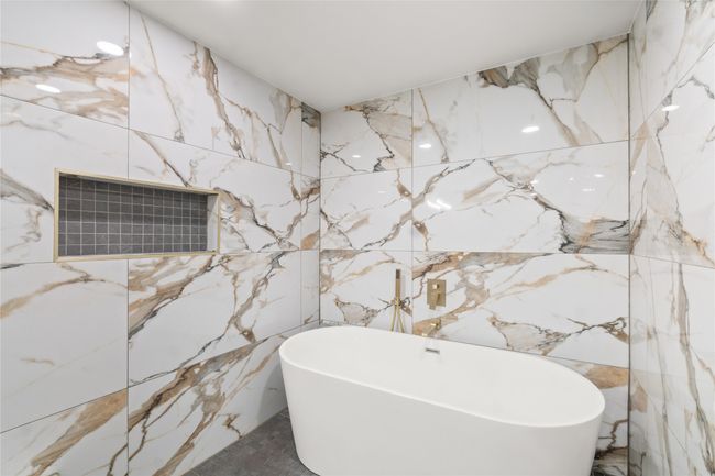 Full bath with a soaking tub and tile walls | Image 19