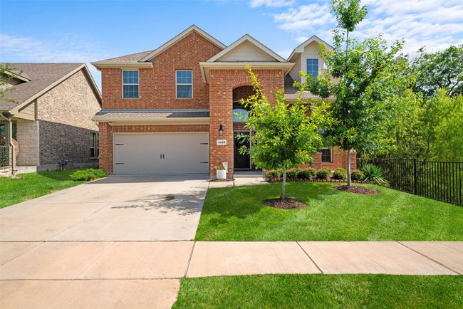 Traditional-style home featuring a garage, brick siding, and driveway | Image 5