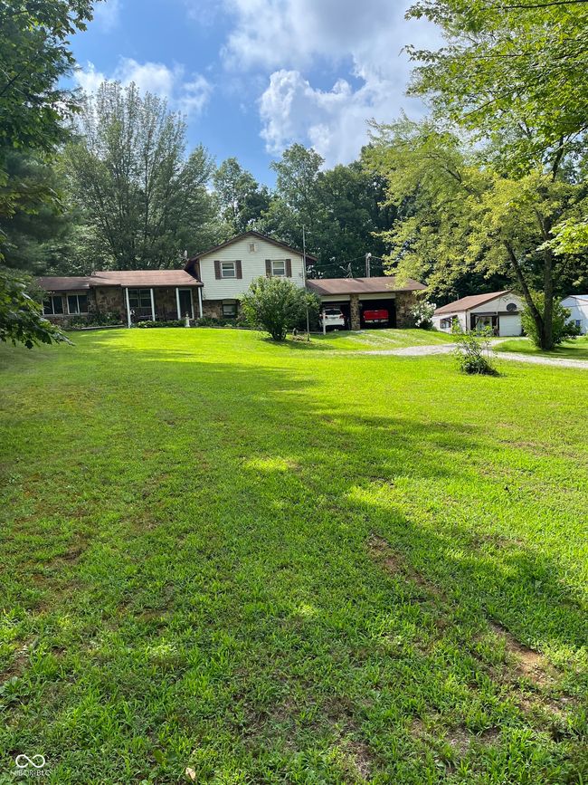 view of grassy yard with driveway and a carport | Image 9