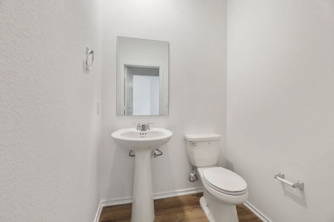 Half bath featuring toilet and wood finished floors | Image 31