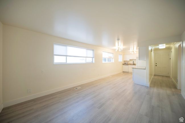 Unfurnished living room with light wood-type flooring | Image 9