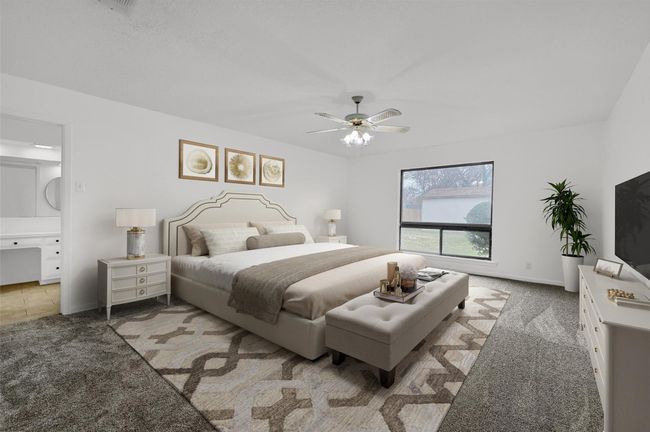 Bedroom featuring carpet flooring, ceiling fan, baseboards, and ensuite bath | Image 15