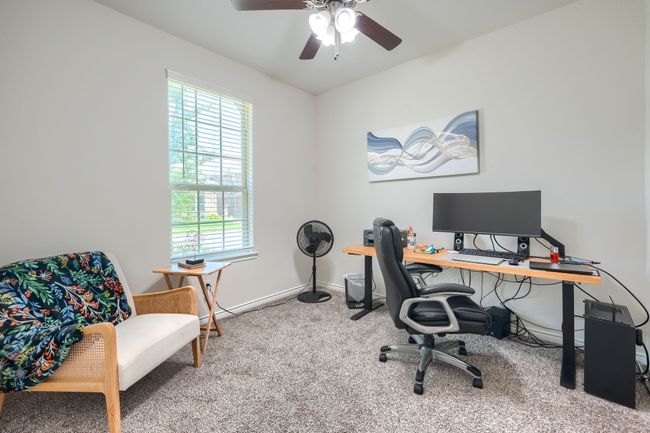 Carpeted office space featuring plenty of natural light, a ceiling fan, and baseboards | Image 15