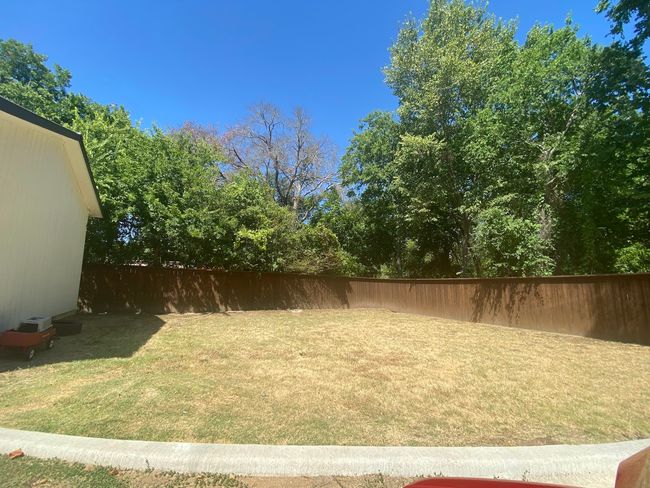 View of fenced backyard | Image 8