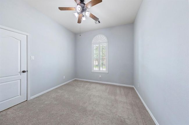 Two secondary bedrooms feature neutral tones, plush carpeting, closets and windows—perfect as bedrooms, home offices, or flex spaces. | Image 16
