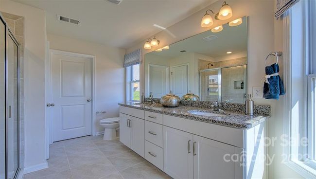Owners Bath with dual sinks, higher vanities | Image 27