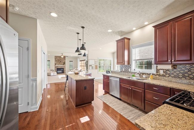 Granite counter tops, tile backsplash and 42" cabinets are added touches to this cook's dream kitchen. | Image 10