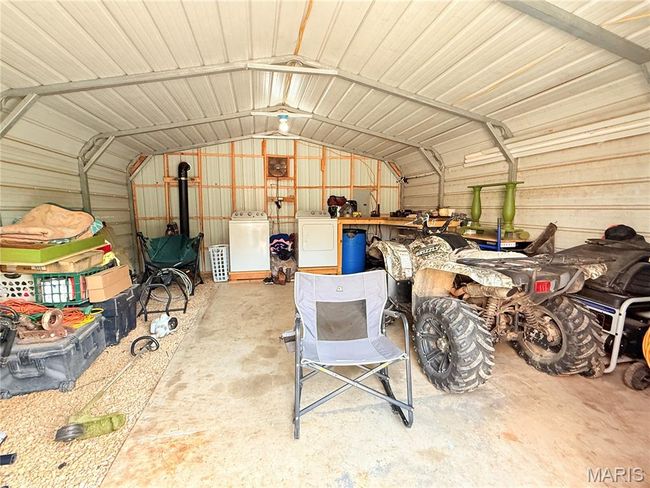 Garage with separate washer and dryer and metal wall | Image 22