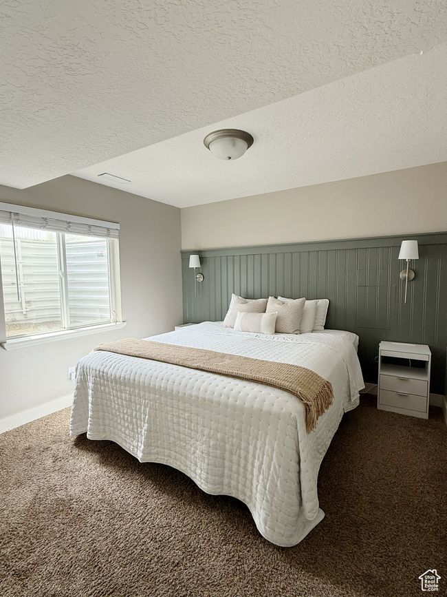 Bedroom featuring carpet floors and a textured ceiling | Image 14