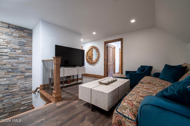 Upstairs, a second living area offers flexible space for movie nights, game days, or a cozy reading nook—perfect for guests, kids, or relaxed evenings in. | Image 16