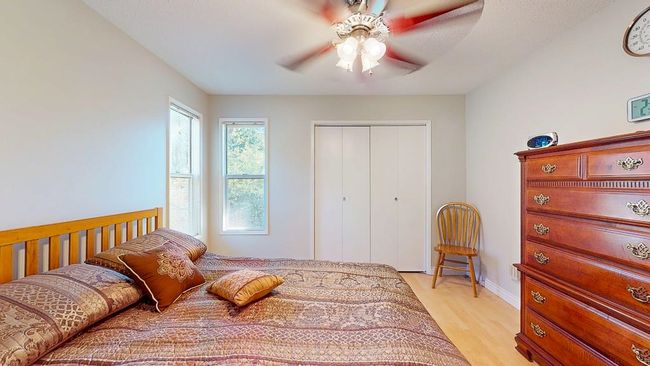 Bedroom featuring light wood-type flooring, and a ceiling fan | Image 17