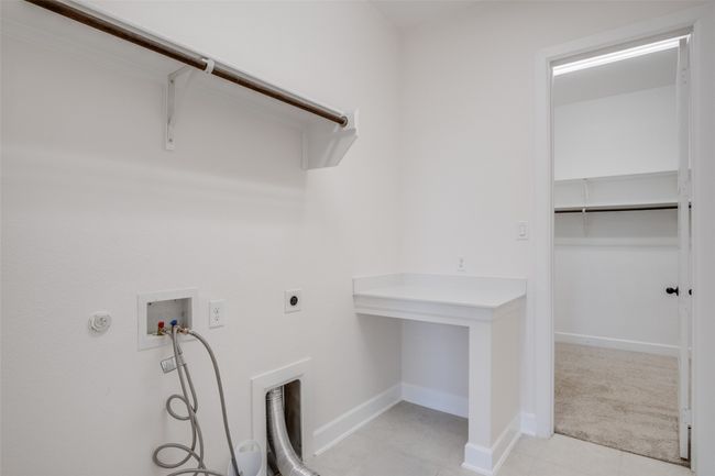 Laundry area with washer hookup, light tile patterned flooring, and hookup for an electric dryer | Image 22