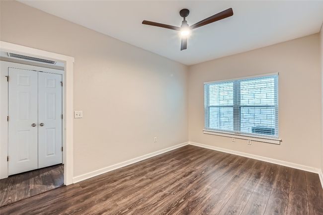 Spare room featuring ceiling fan and dark wood finished floors | Image 7