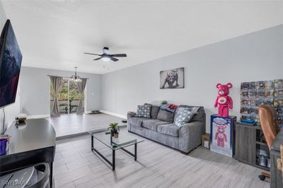 Living room featuring ceiling fan and light wood-type flooring | Image 2