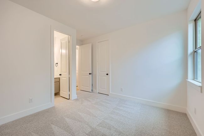 Unfurnished bedroom featuring multiple windows, light carpet, and baseboards | Image 23