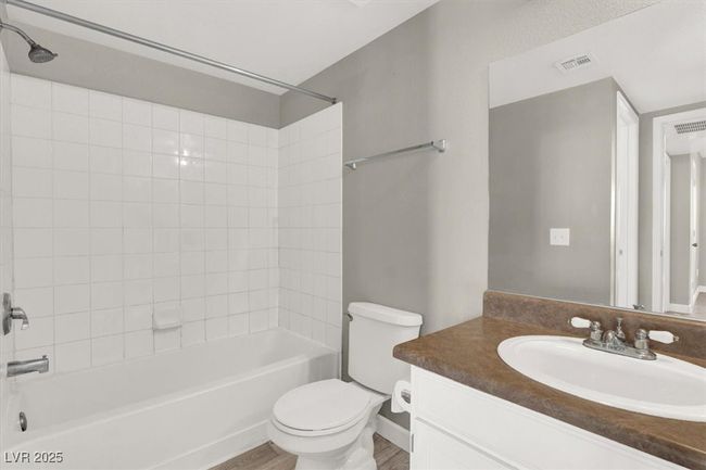 Bathroom with toilet, vanity, visible vents, and bathing tub / shower combination | Image 22