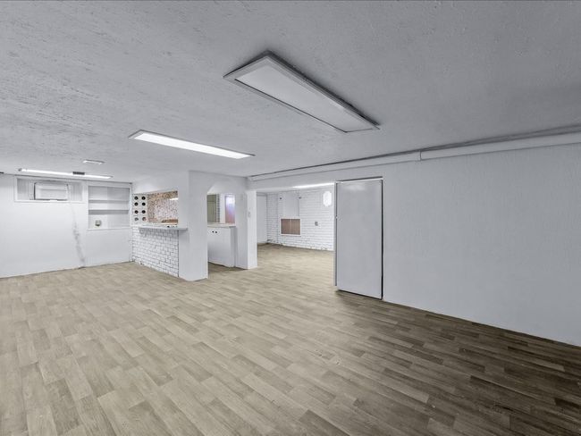 Below grade area with wood finished floors and a textured ceiling | Image 29