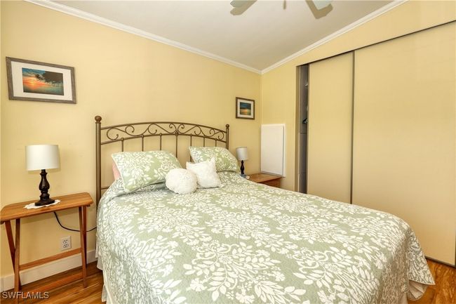 Bedroom with ceiling fan, a closet, crown molding, and hardwood / wood-style flooring | Image 18