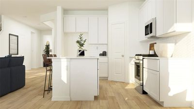 Kitchen featuring decorative backsplash, appliances with stainless steel finishes, white cabinets, and light hardwood / wood-style floors | Image 3