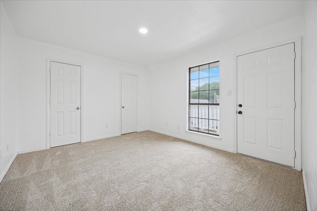 This bedroom features another door to the balcony overlooking the backyard. | Image 35