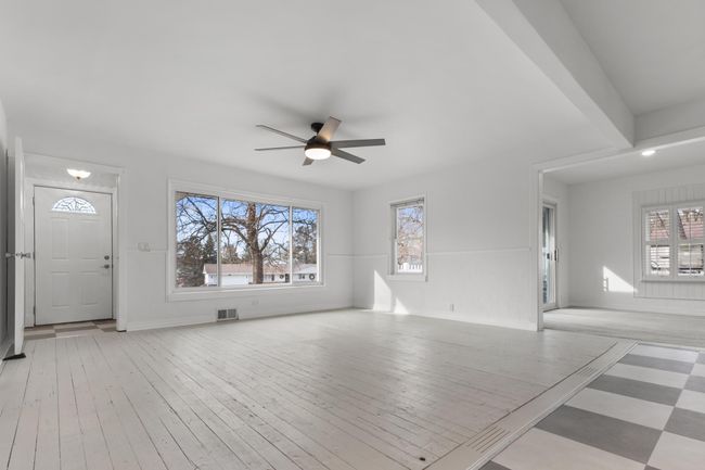 Large windows frame views of the expansive yard, fully fenced for privacy and perfect for kids, pets, and weekend barbecues. | Image 5