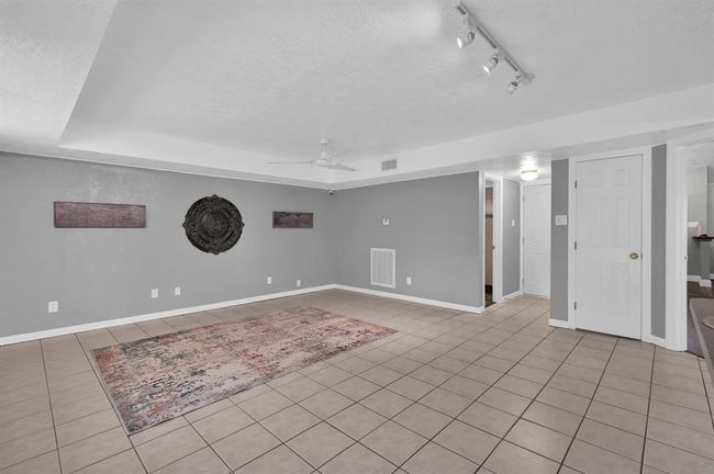 Open door pictured is the half bath and far closed door is the entrance to the garage. The other closed door is a walk in pantry/storage area | Image 12