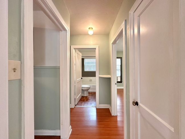 Hall with wood finished floors and baseboards | Image 11