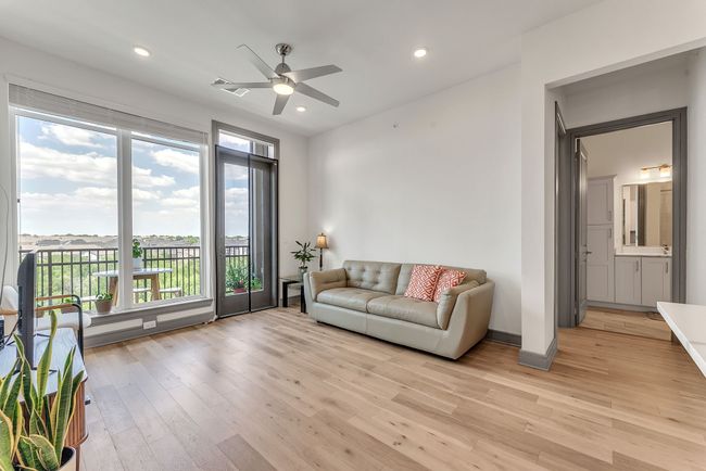 Living room featuring light wood finished floors, a ceiling fan, and recessed lighting | Image 8