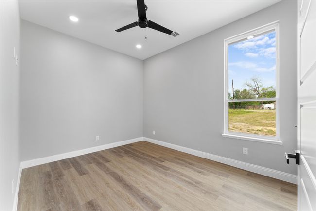 Empty room featuring baseboards, ceiling fan, wood finished floors, and visible vents | Image 16