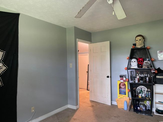 Bedroom featuring concrete flooring and ceiling fan | Image 29