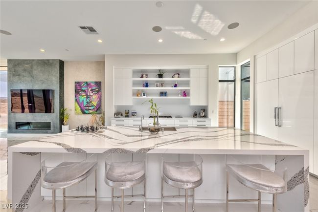 Kitchen featuring visible vents, open shelves, light stone counters, and recessed lighting | Image 4