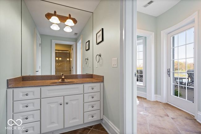 Another full bath in the basement is conveniently located off the pool deck, making for easy changes and showering. | Image 42