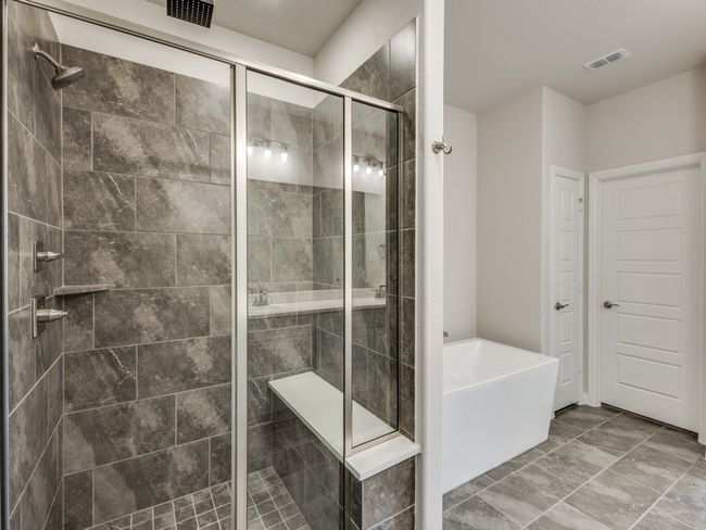 Whether is a long, luxurious shower or soaking your cares away in the freestanding tub, this wonderful owner's bath is the perfect place to start or end your day. | Image 12