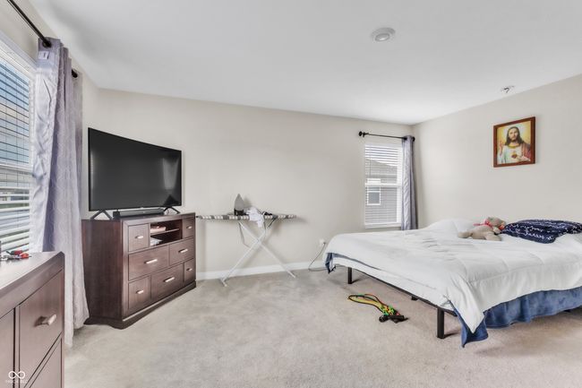 bedroom with light carpet and baseboards | Image 19