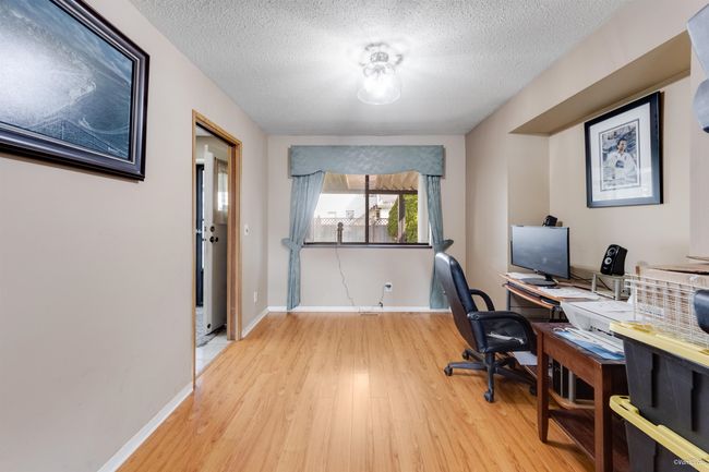 Dining room with light wood finished floors, a textured ceiling, and baseboards | Image 5