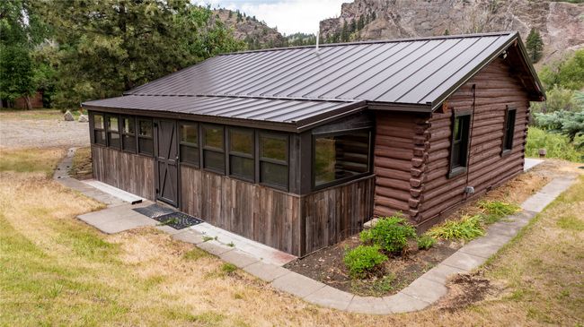 View of side of home with log siding and a metal roof | Image 51