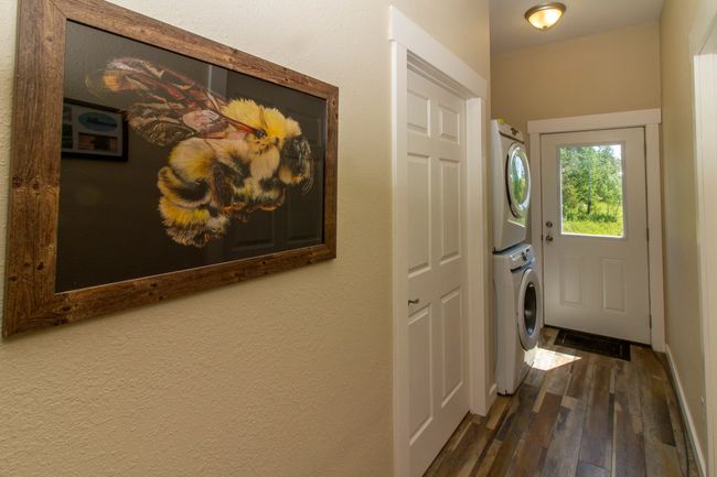 Hallway featuring stacked washer / dryer and dark wood-style floors | Image 6