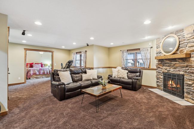 Lower level family room with additional stone fireplace | Image 24