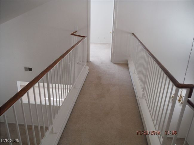 Corridor featuring an upstairs landing, visible vents, and carpet floors | Image 6