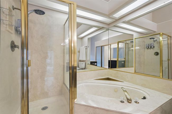 Bathroom featuring a jetted tub and a stall shower | Image 13
