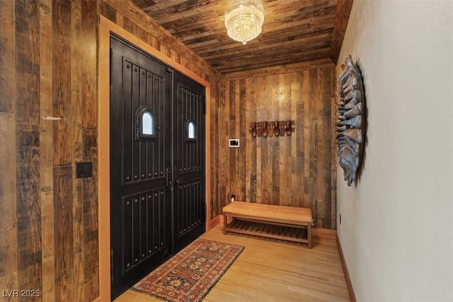 Entryway with wood ceiling, wooden walls, baseboards, and wood finished floors | Image 26