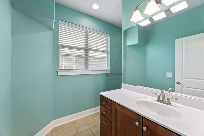 Bathroom with vanity and tile patterned floors | Image 14
