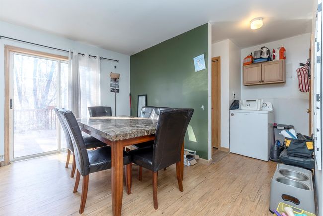 Dining room with light wood finished floors and washer / dryer | Image 26