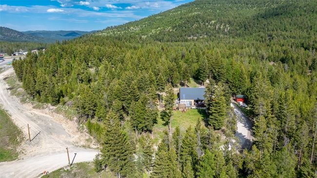 Aerial view of property's location featuring a forest and a mountainous background | Image 72
