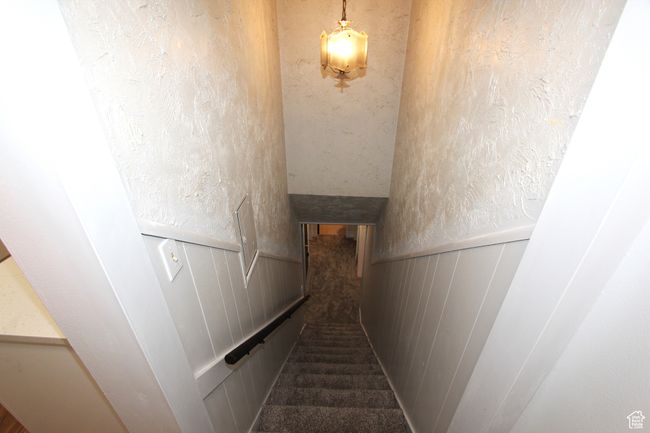 Staircase featuring carpet floors and wainscoting | Image 21