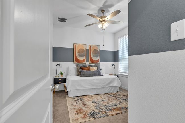 Bedroom featuring a ceiling fan and a textured wall | Image 7