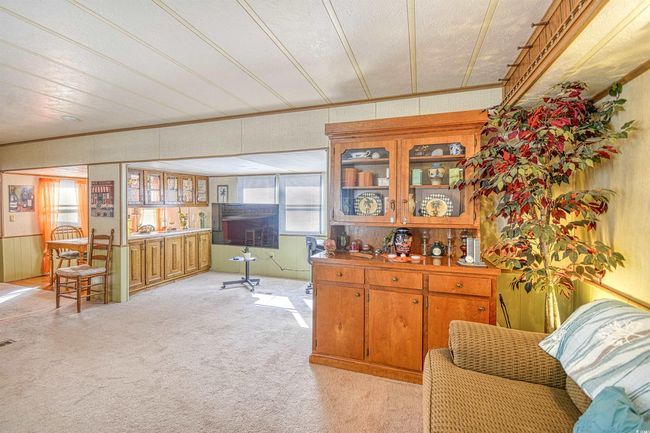 Interior space with light colored carpet and crown molding | Image 9