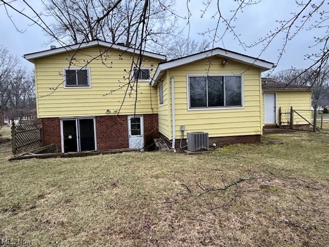 Back of property featuring central AC and a yard | Image 19
